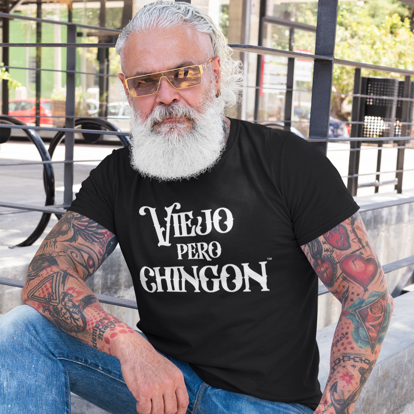 Older Man with White Hair and Tattoos wearing a black shirt with white text that says Viejo Pero Chingon
