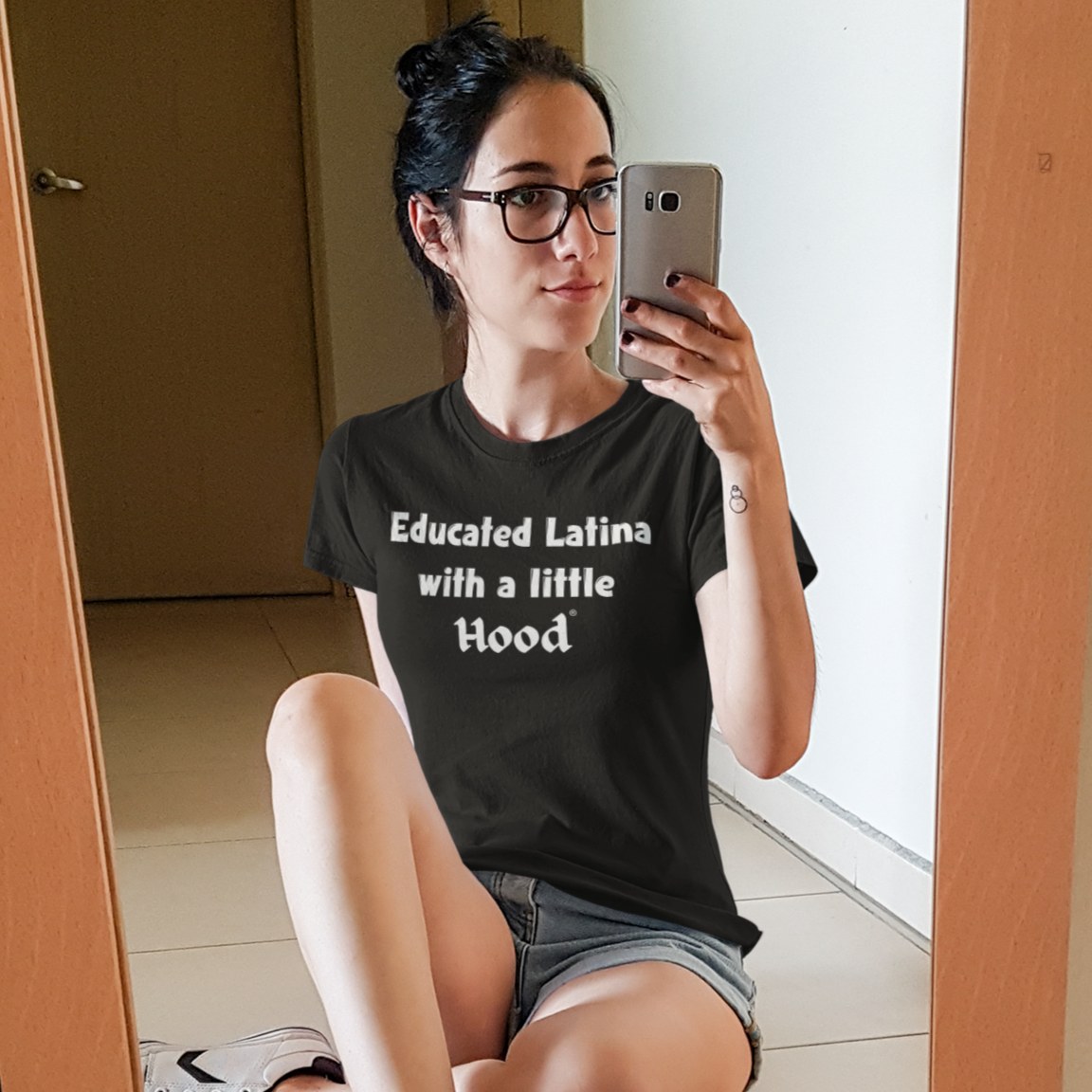 Young woman wearing Educated Latina with a Little Hood Real One T-Shirt