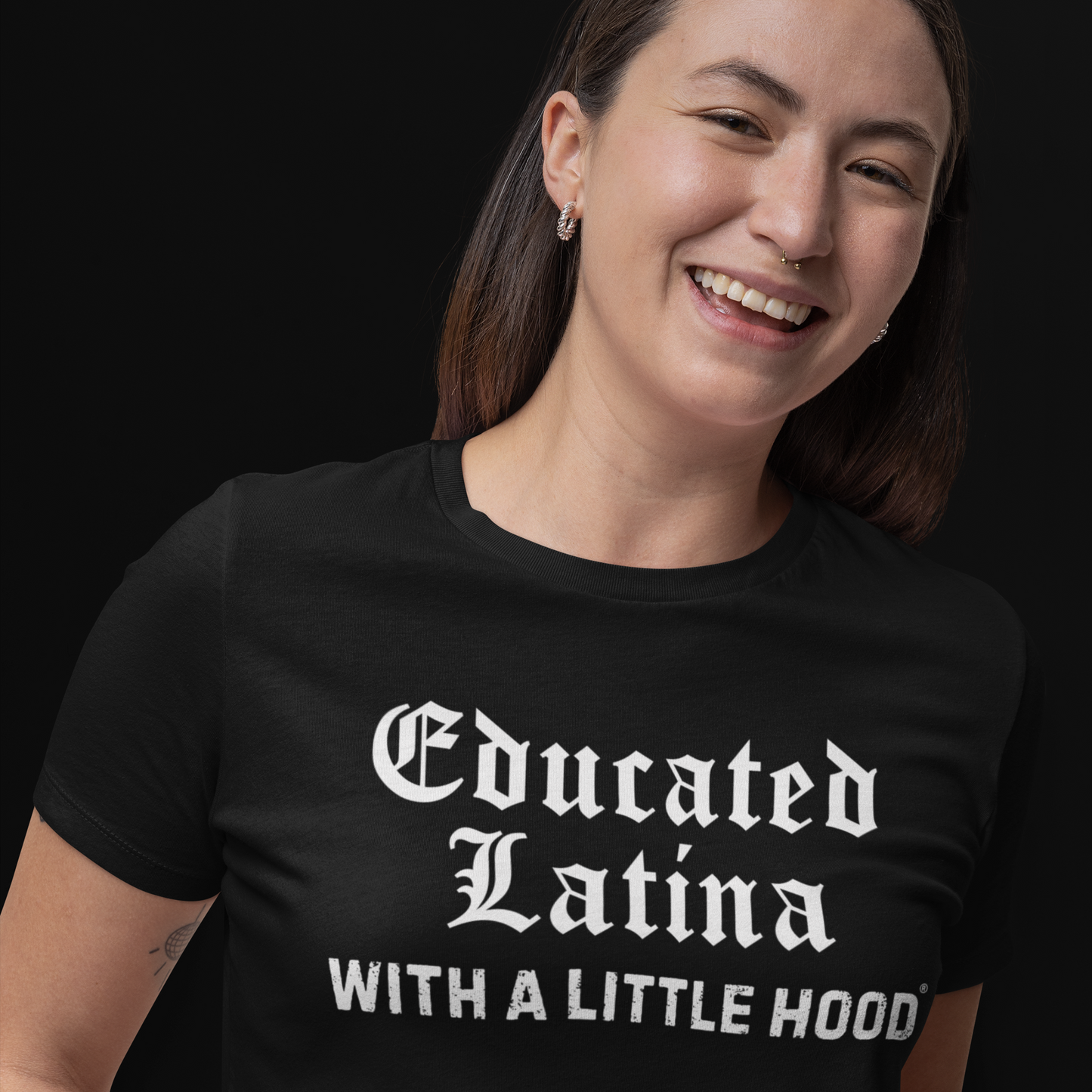 Woman wearing a black t-shirt with 'Educated Latina With A Little Hood' text on a black background